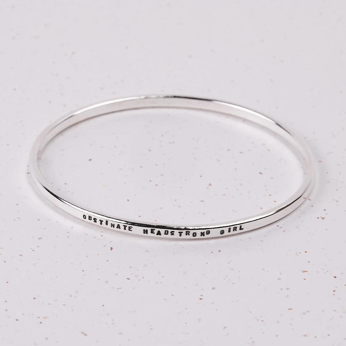 Bracelet wih "Obstinate Headstrong Girl" stamped into it